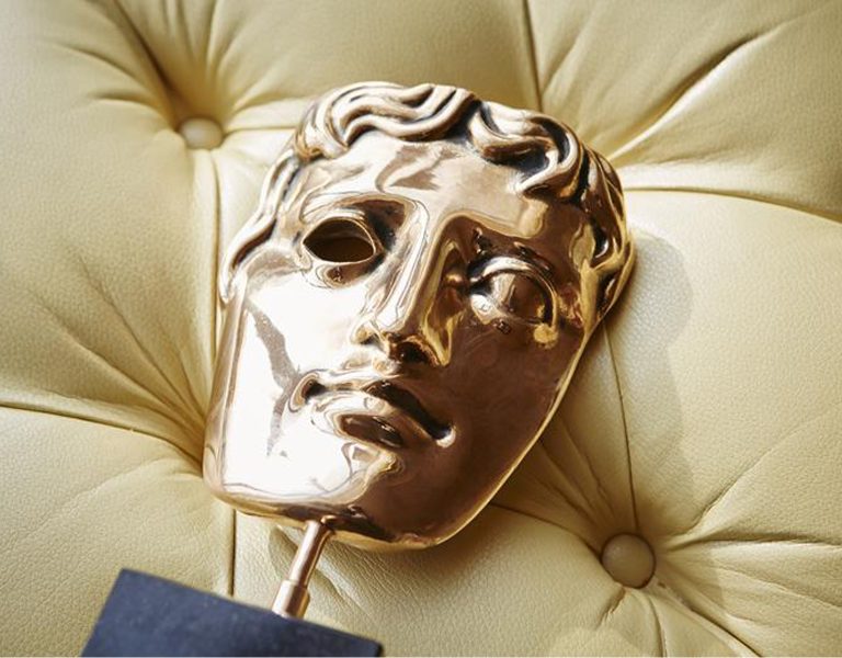 A BAFTA trophy on a sofa