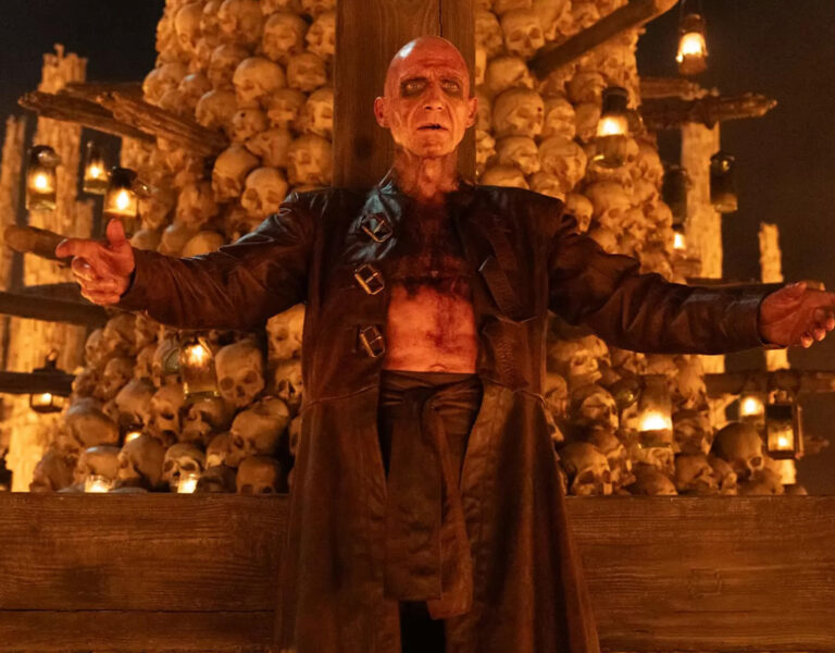 Ralph Fiennes with arms outstretched