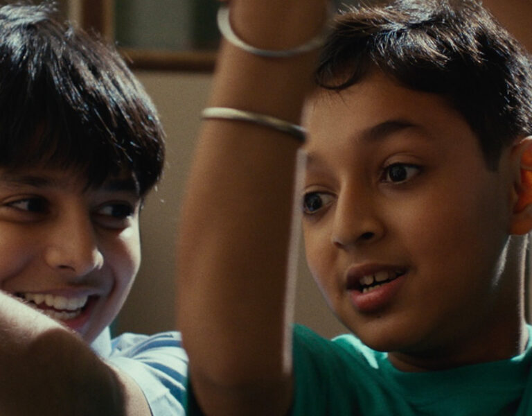 Two boys with arms aloft