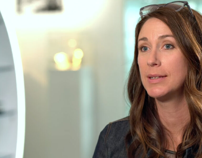 Alicia Robbins talking with glasses on her head