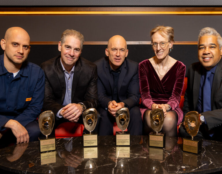 The F1 sound team sitting with their trophies