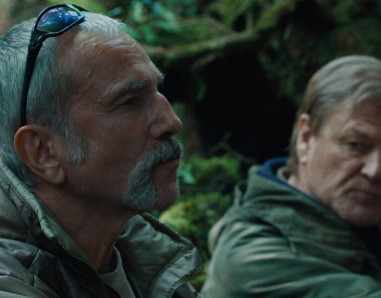 Two men sat looking tense