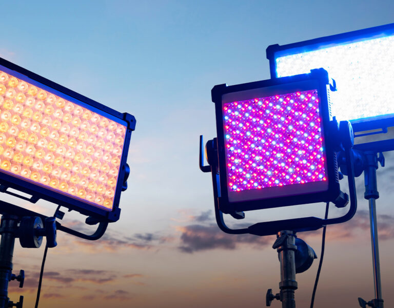 Three lights against a blue sky