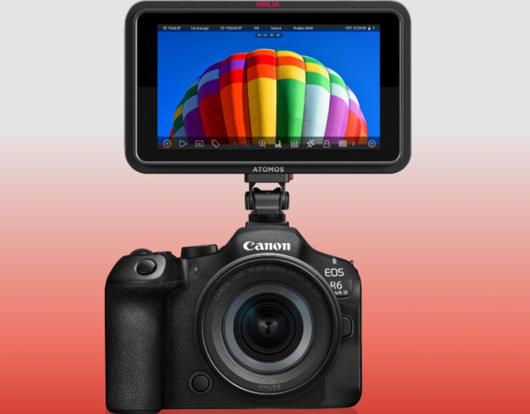 A Canon EOS R6 Mk III camera with a large Atomos Ninja external monitor, capable of ProRes RAW recording, displays a photo of a colourful hot air balloon against a blue sky on a red-to-white gradient background.
