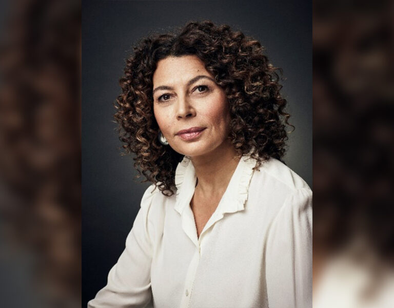 A woman smiling into camera