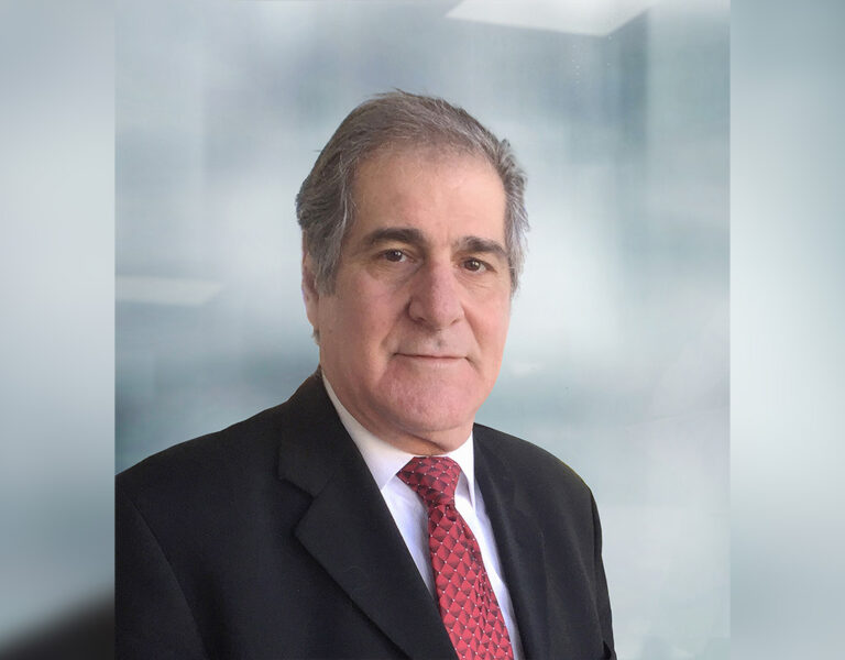 A man in a suit looking into camera