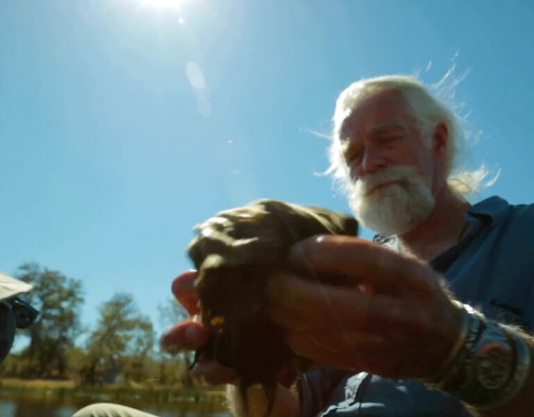 Dereck Joubert looking at a rag