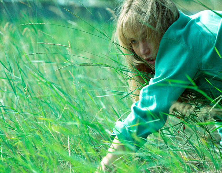 Jennifer Lawrence crawling through grass