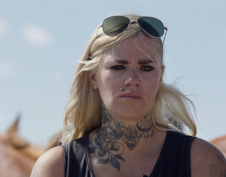 A woman with sunglasses on her head looking sad