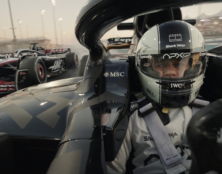 Brad Pitt in an F1 car looking in his mirror