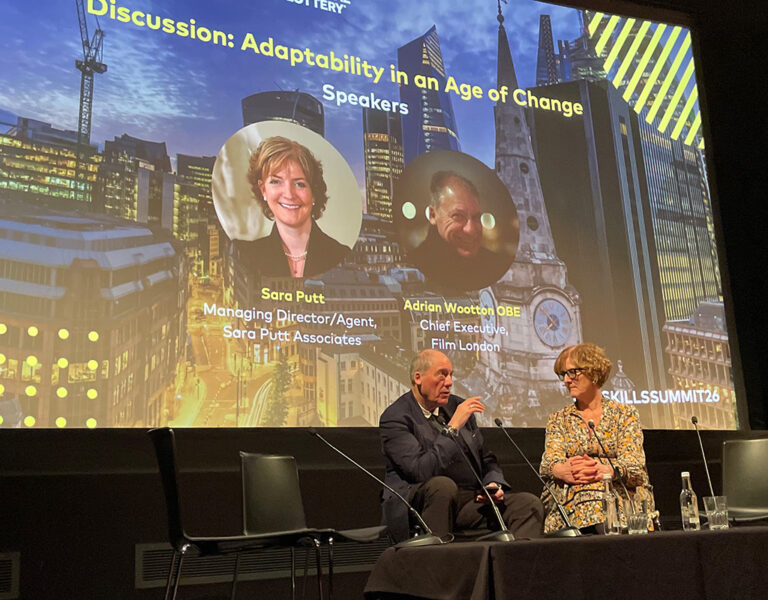 Two people speaking at a Q&A