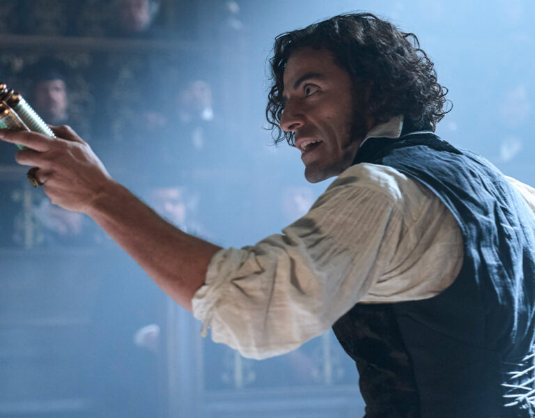 Oscar Isaac holding a scroll