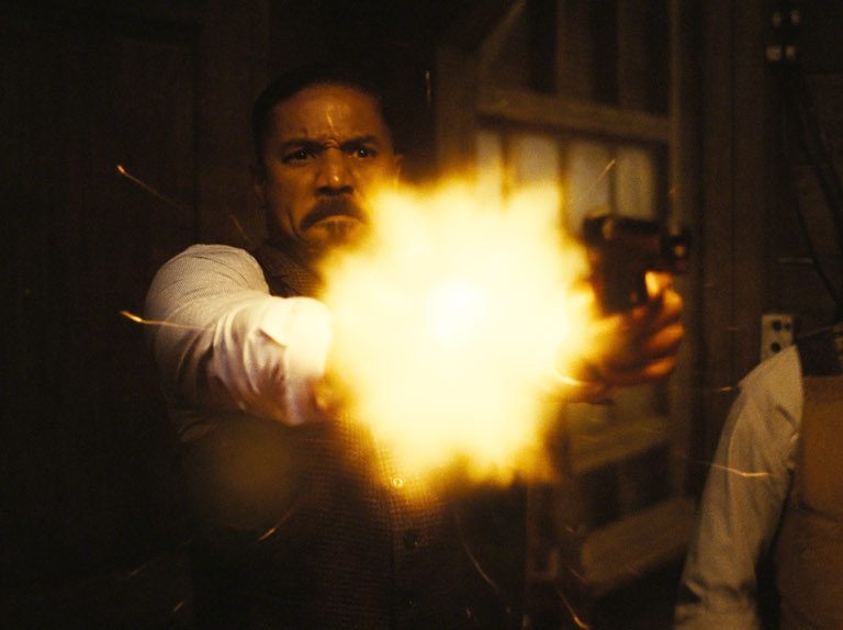 Michael B Jordan shooting a gun