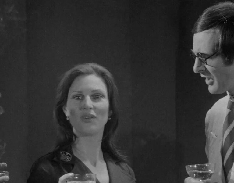 People in formal attire talking together