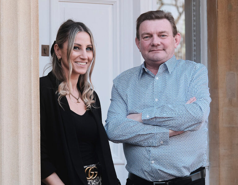 Two people stood together smiling