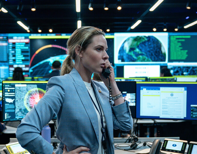 Rebecca Ferguson on the phone in a control room