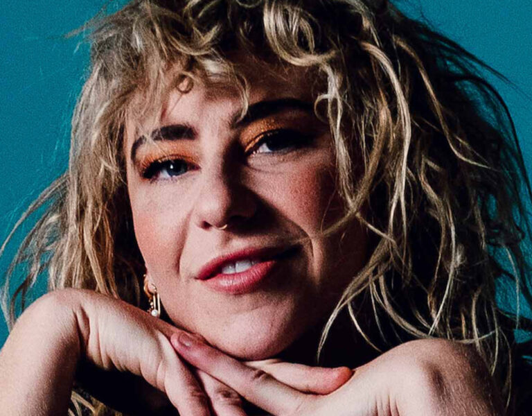 Jessie Hughes with hands under chin