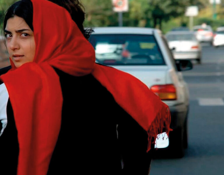 A woman in a headscarf on a motorbike