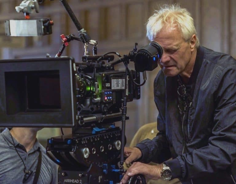 Kees Van Oostrum looking through a camera