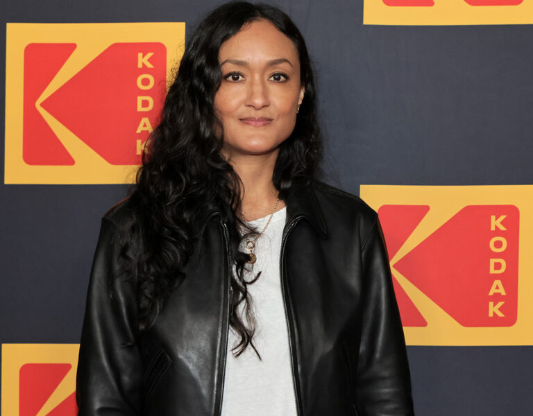 Arkapaw stood smiling on a red carpet