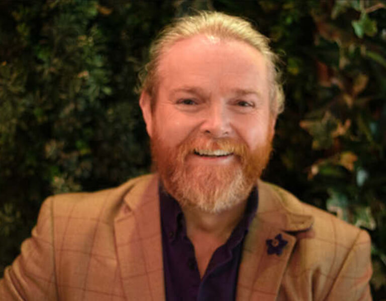 Michael Beavan smiling into camera