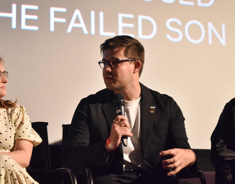 Three people talking on stage