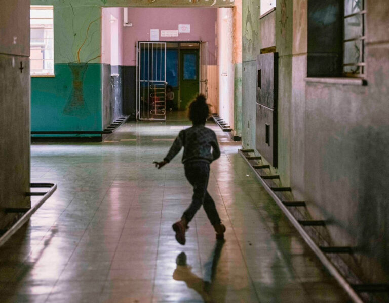 A girl running through a corridor