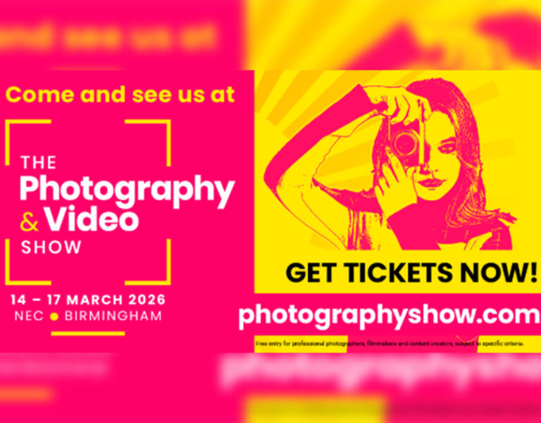 A pink and yellow poster for Nikon's stand at the Photography and Video Show