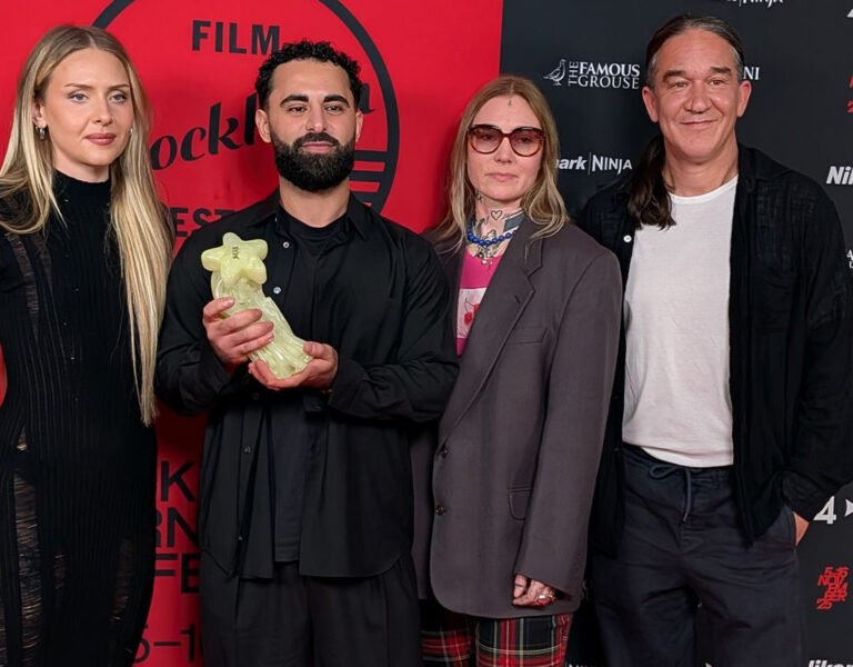 Jury and award winner posing with the trophy