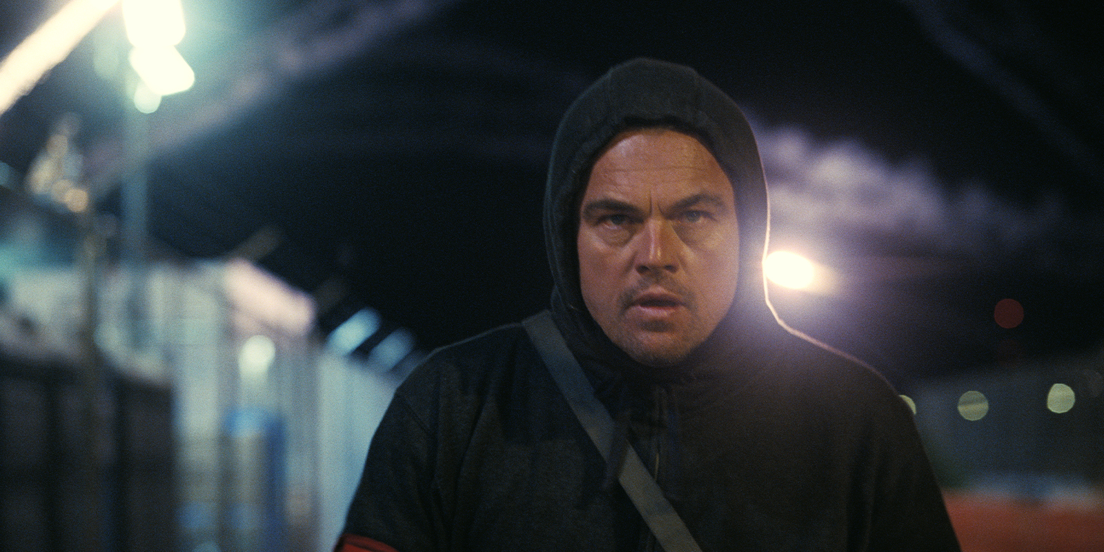 Leonardo Dicaprio in a black hoodie walking