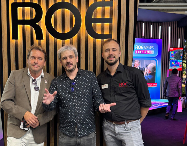 People gathered in front of a ROE sign