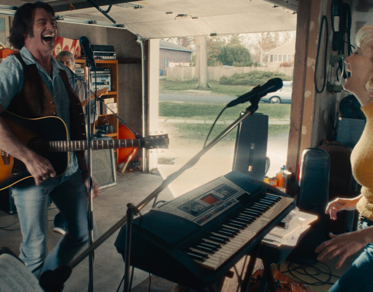 Two people singing in their garage