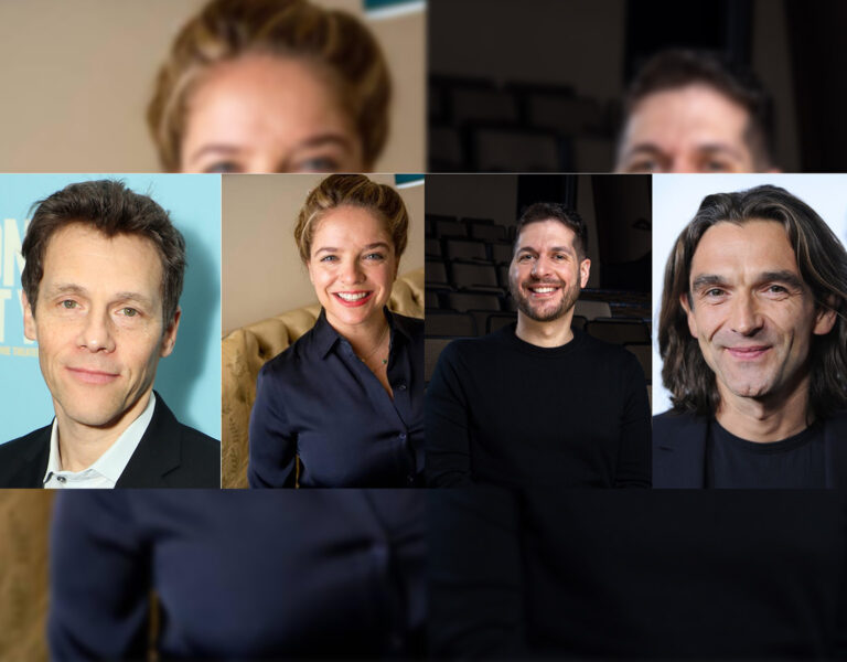 Four people smiling into camera