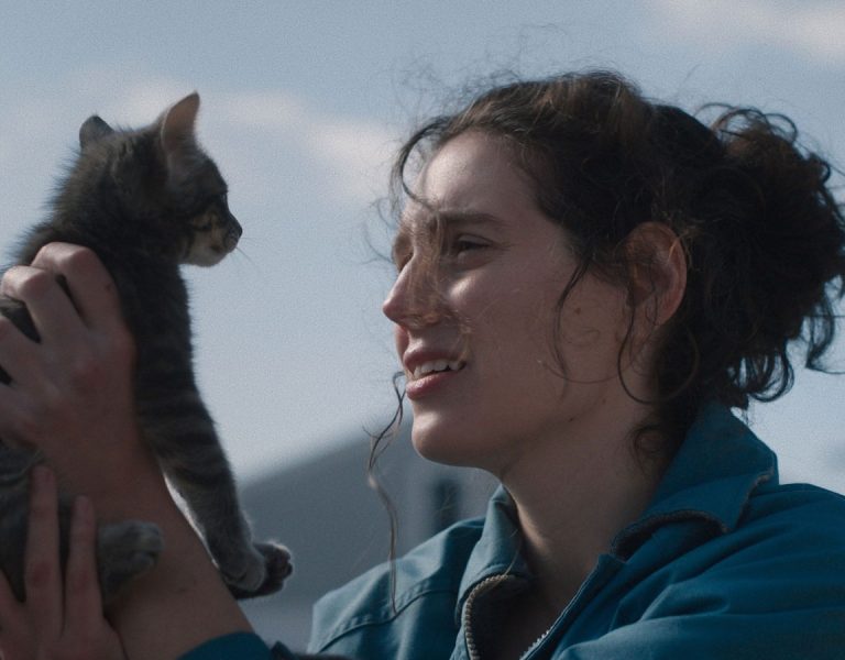 A woman looking at a cat