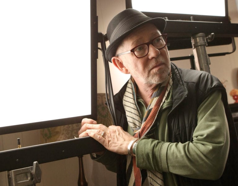 Steven Poster stood by a large light