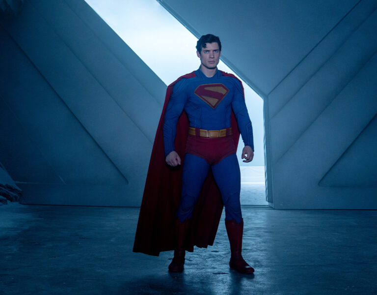 Superman in front of a door