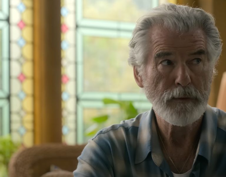 Pierce Brosnan sat in a plaid shirt