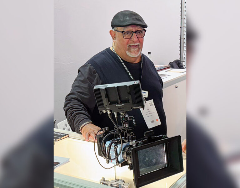 Ibrahim standing behind a camera