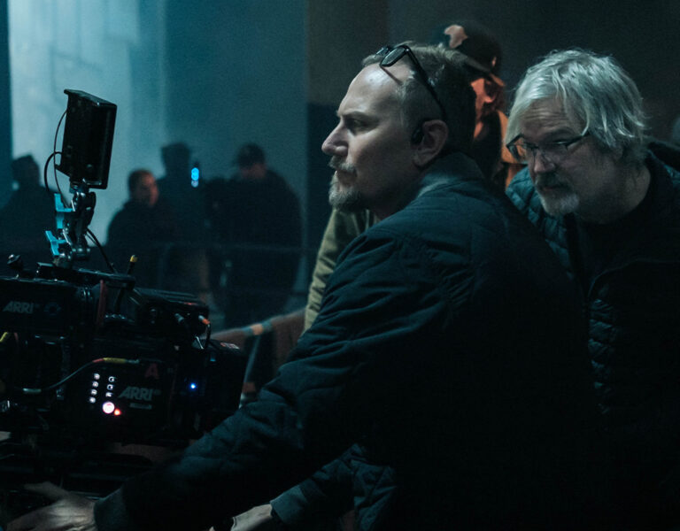 Film crew on set in a darkened room