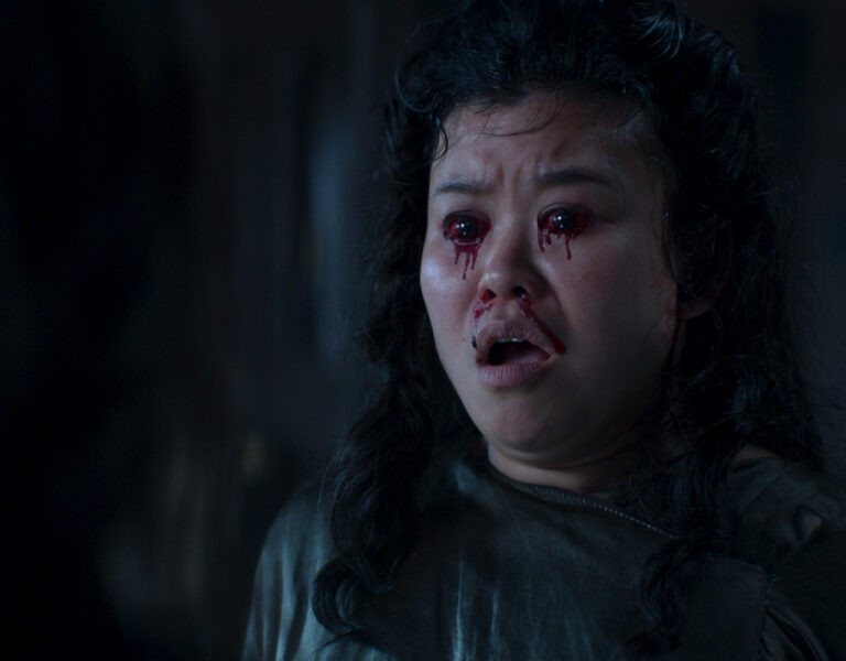 A woman with blood pouring out of her eyes