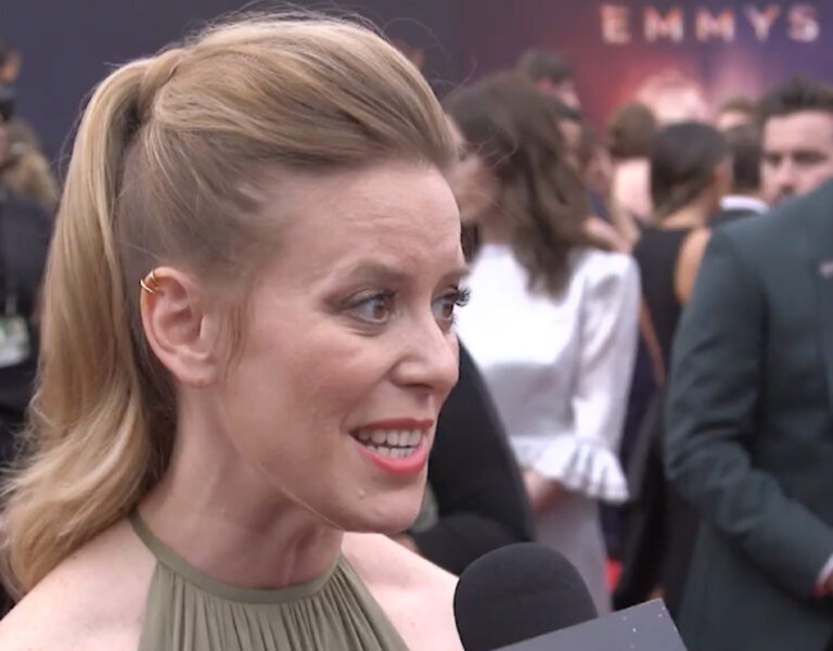 Zoë White speaking into a microphone